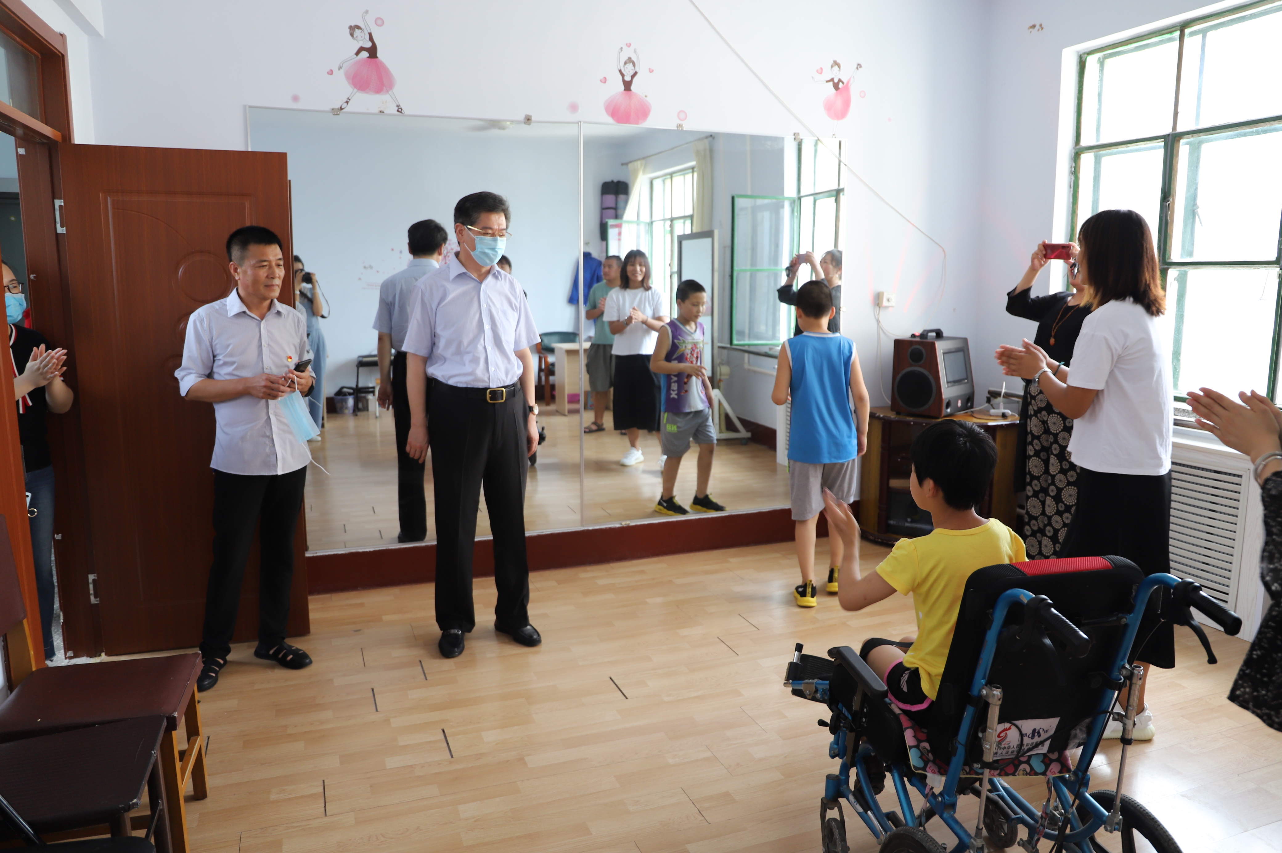 图为省残联党组成员、副理事长张志斌（左二）走访北票市残疾人康复托养中心